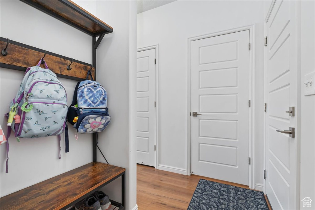 Mudroom featuring wood finished floors and baseboards