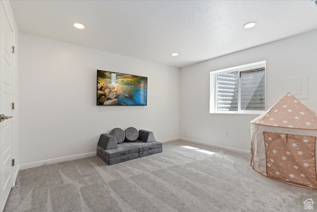Living area with carpet floors, recessed lighting, and baseboards