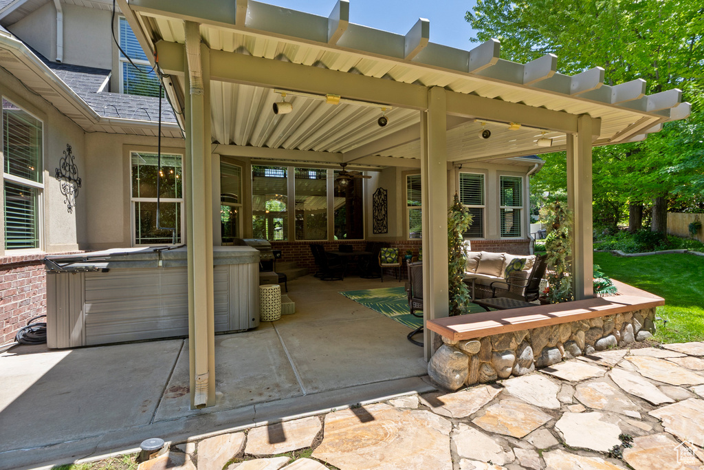 View of patio featuring a hot tub