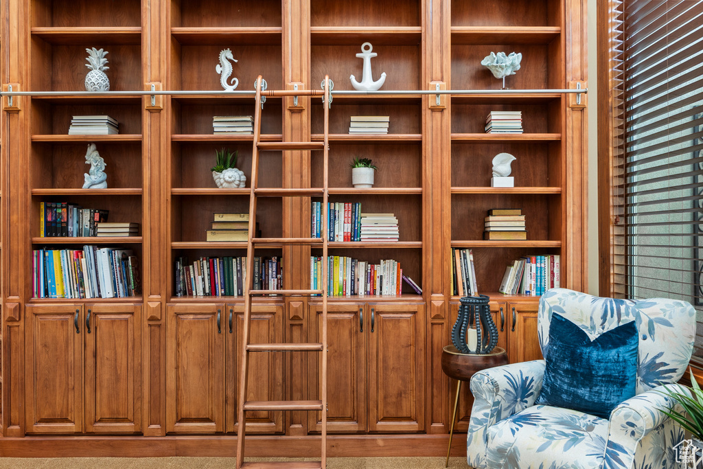 Sitting room featuring built in shelves