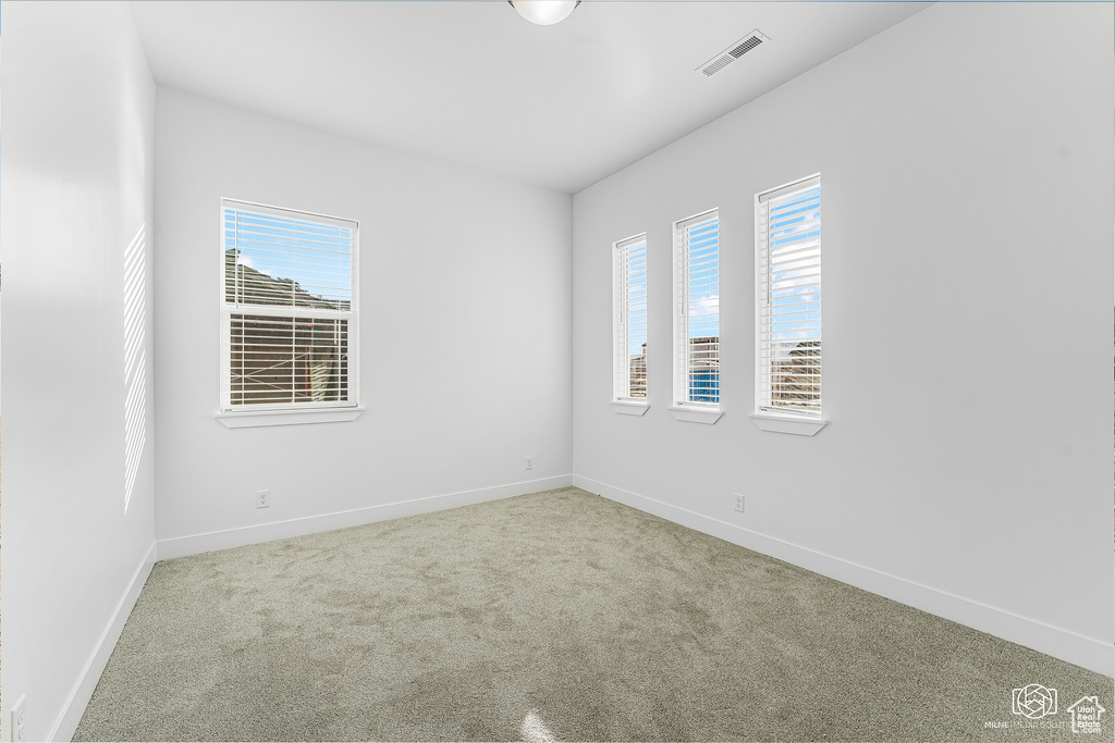 Empty room with carpet flooring and baseboards