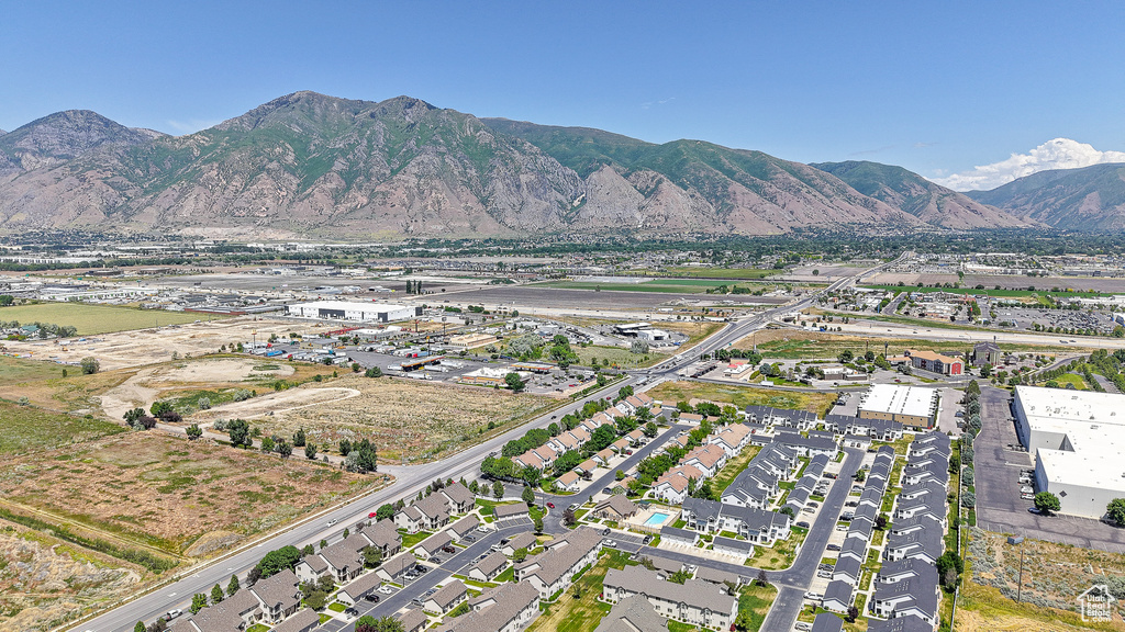 Aerial view of property and surrounding area featuring a mountainous background