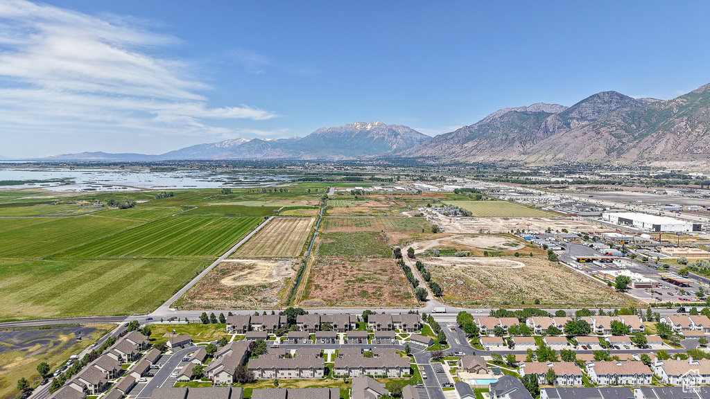 Aerial view of property and surrounding area with a water and mountain view