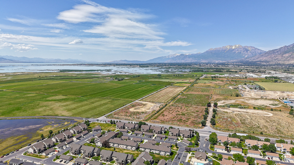 Aerial view of property and surrounding area with a water and mountain view