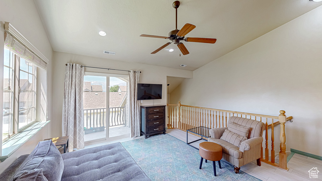 Sitting room featuring vaulted ceiling, ceiling fan, recessed lighting, and an upstairs landing