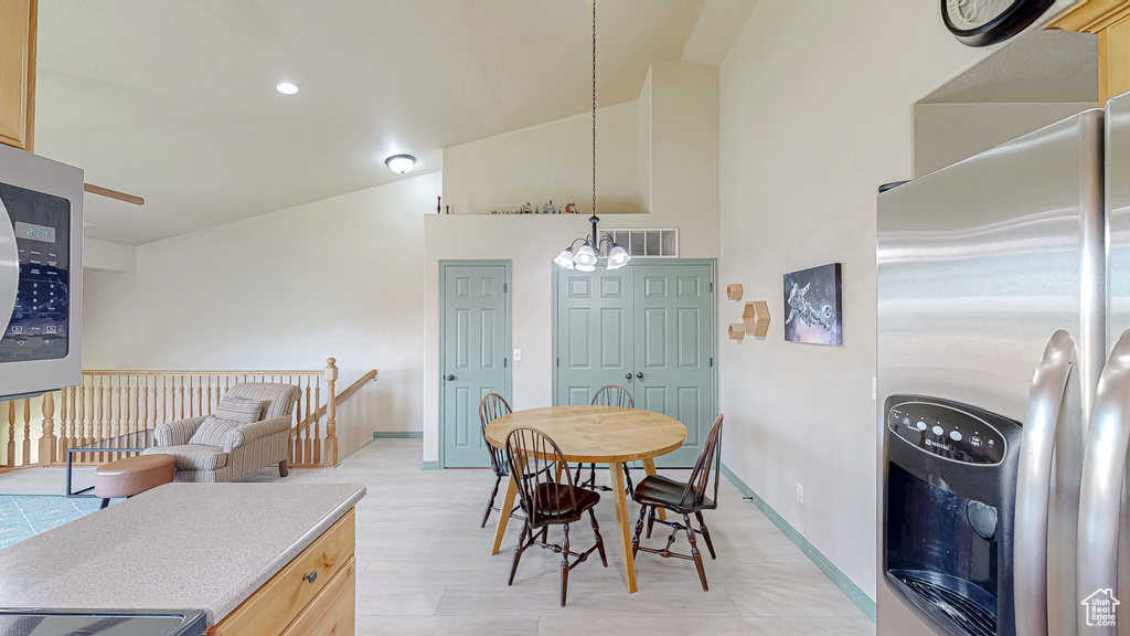 Dining room featuring a chandelier, baseboards, vaulted ceiling, and recessed lighting