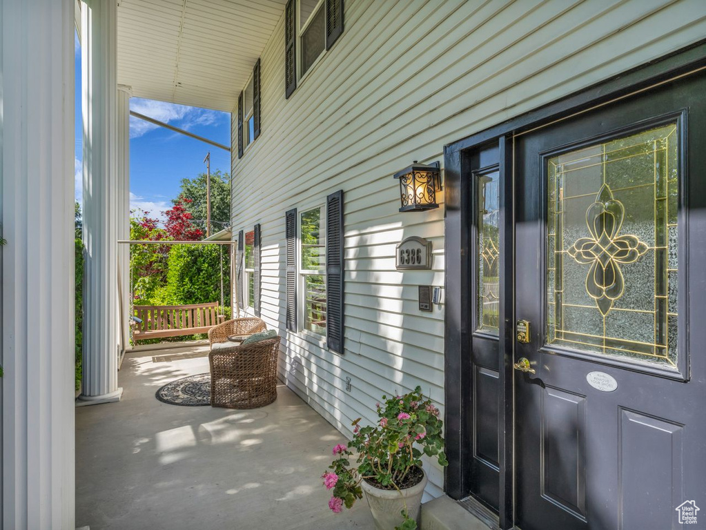 Entrance to property featuring covered porch