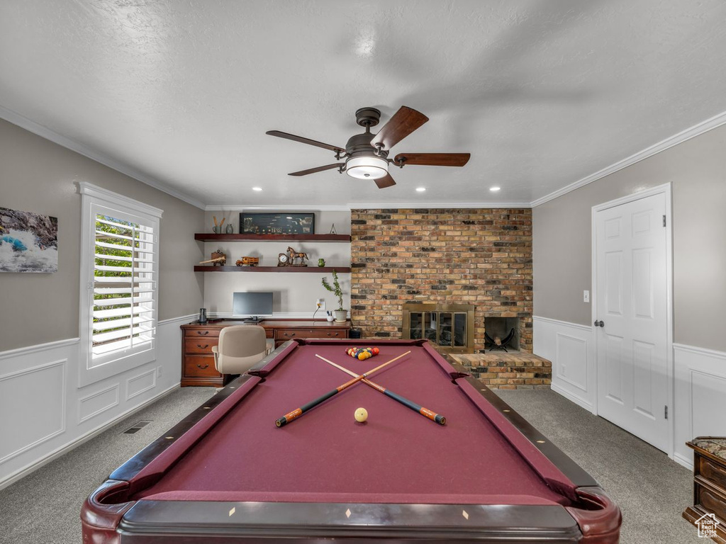 Game room with carpet flooring, billiards, a wainscoted wall, a ceiling fan, and crown molding