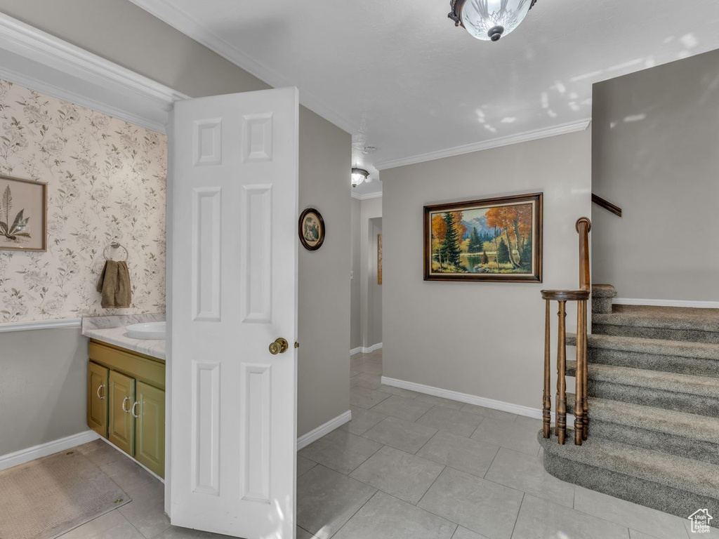Bathroom featuring ornamental molding, vanity, tile patterned floors, and baseboards