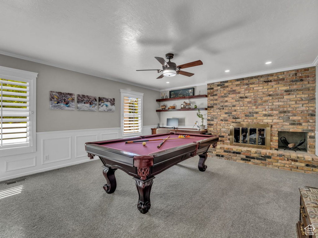 Recreation room featuring carpet floors, a ceiling fan, pool table, ornamental molding, and wainscoting