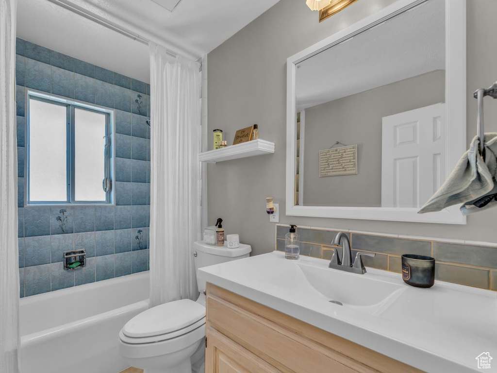 Full bath featuring vanity, toilet, and shower / bath combo