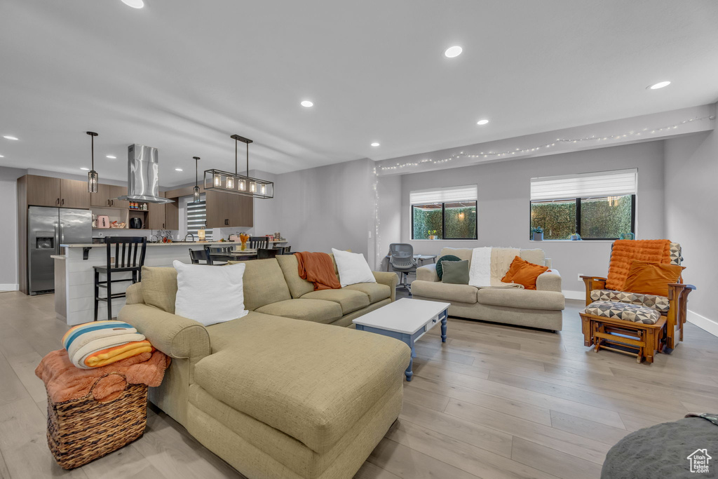 Living area featuring recessed lighting, baseboards, and light wood finished floors