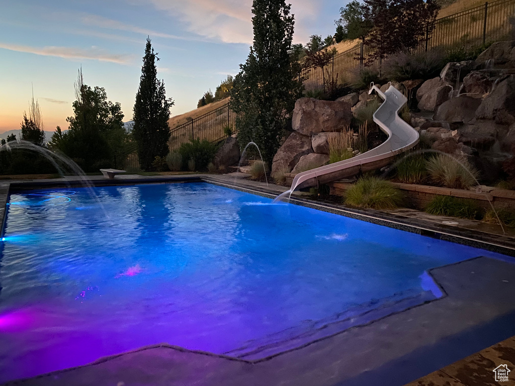 View of pool with a water slide
