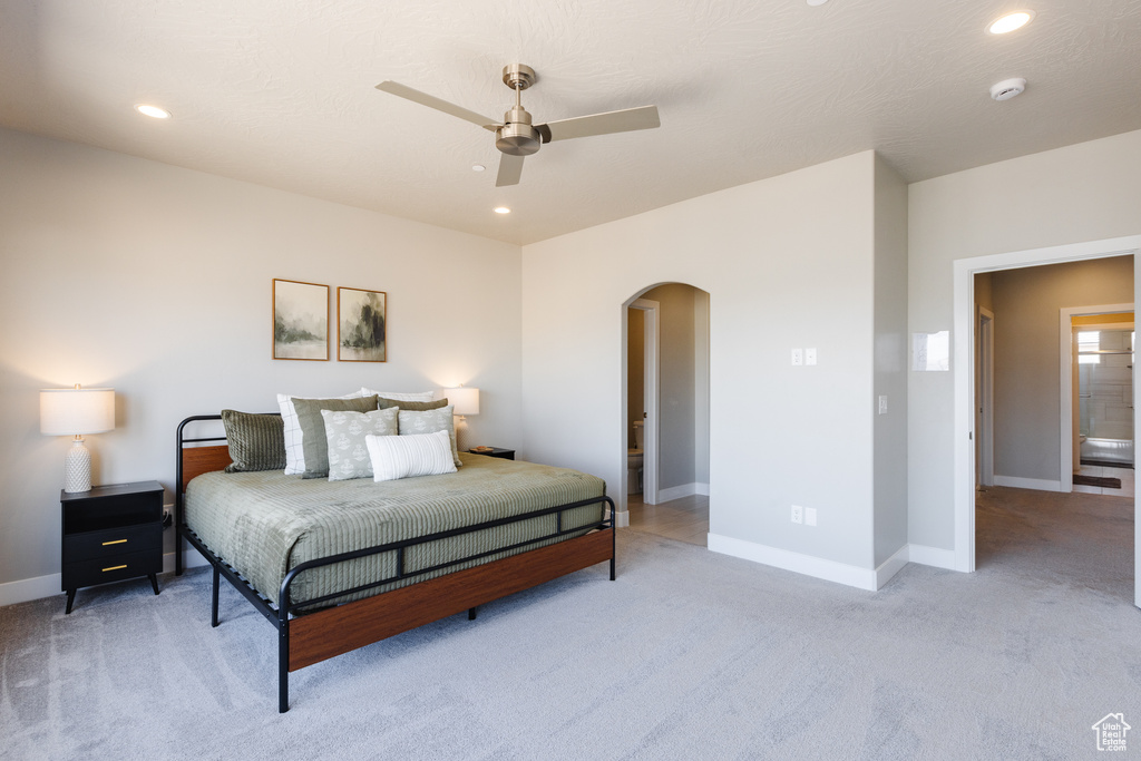 Bedroom featuring arched walkways, carpet flooring, recessed lighting, baseboards, and ceiling fan