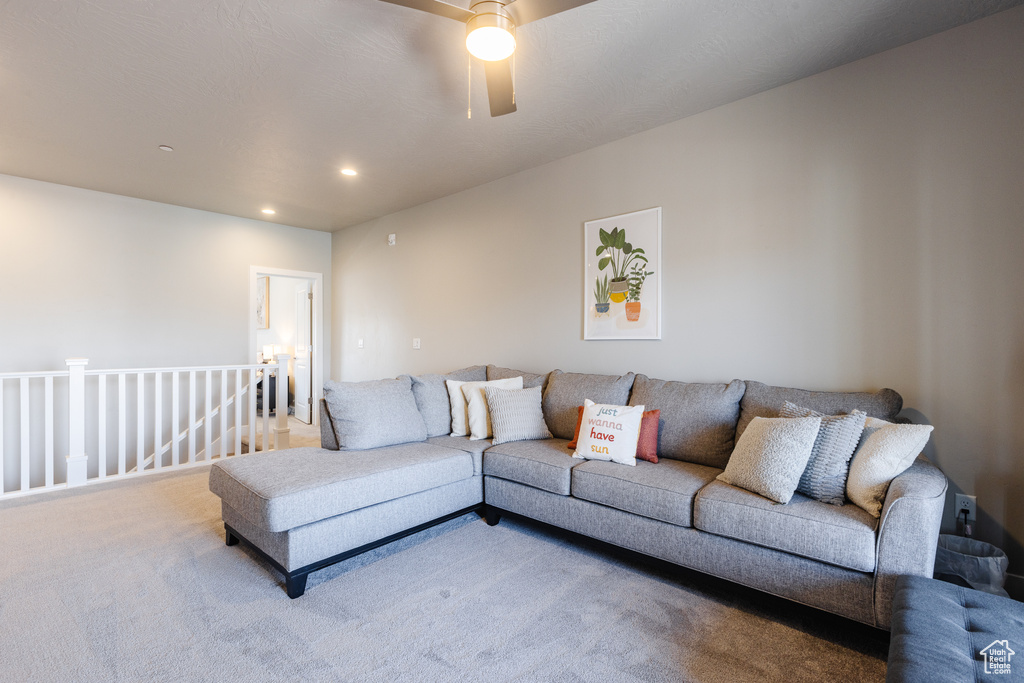 Living area featuring carpet flooring, a ceiling fan, and recessed lighting