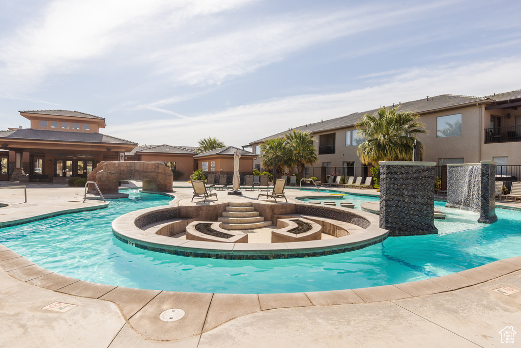 Community pool featuring a hot tub and a patio area