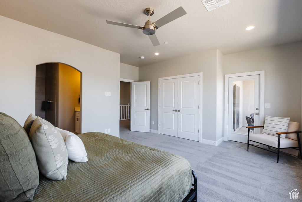 Carpeted bedroom with arched walkways, recessed lighting, a closet, baseboards, and ceiling fan