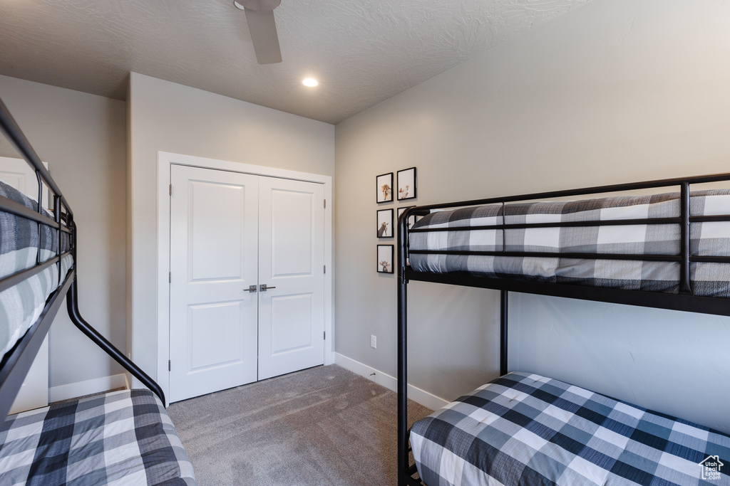 Carpeted bedroom with baseboards, ceiling fan, and recessed lighting