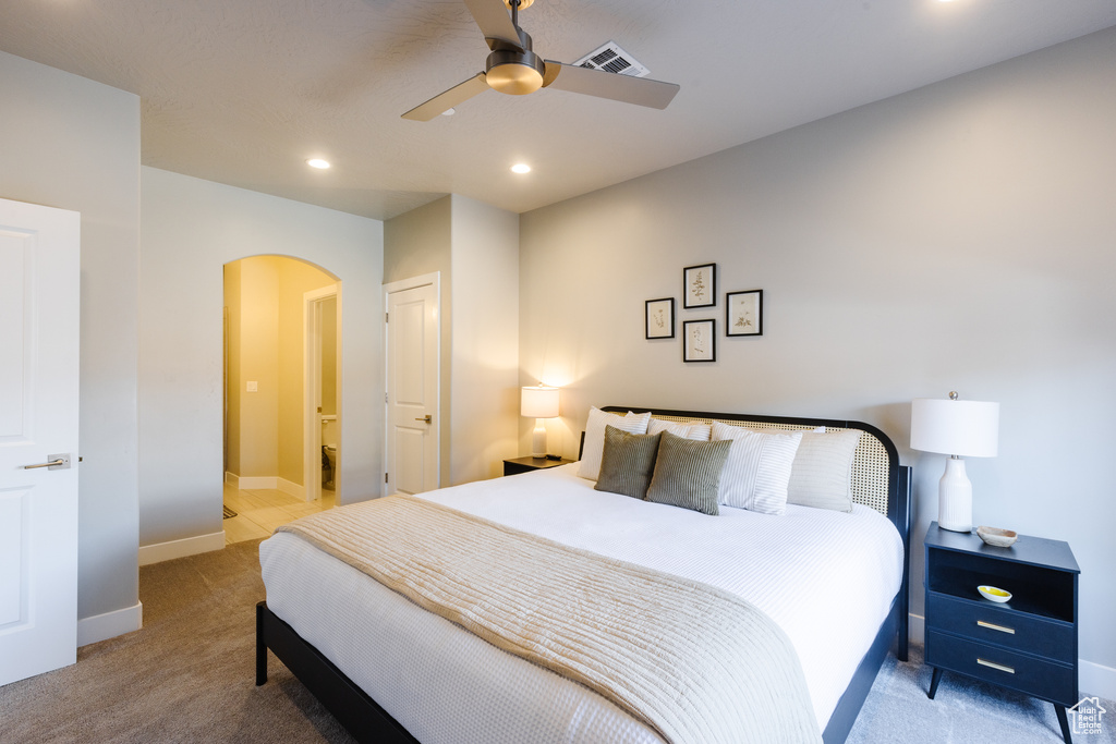 Bedroom featuring arched walkways, carpet, baseboards, ceiling fan, and recessed lighting
