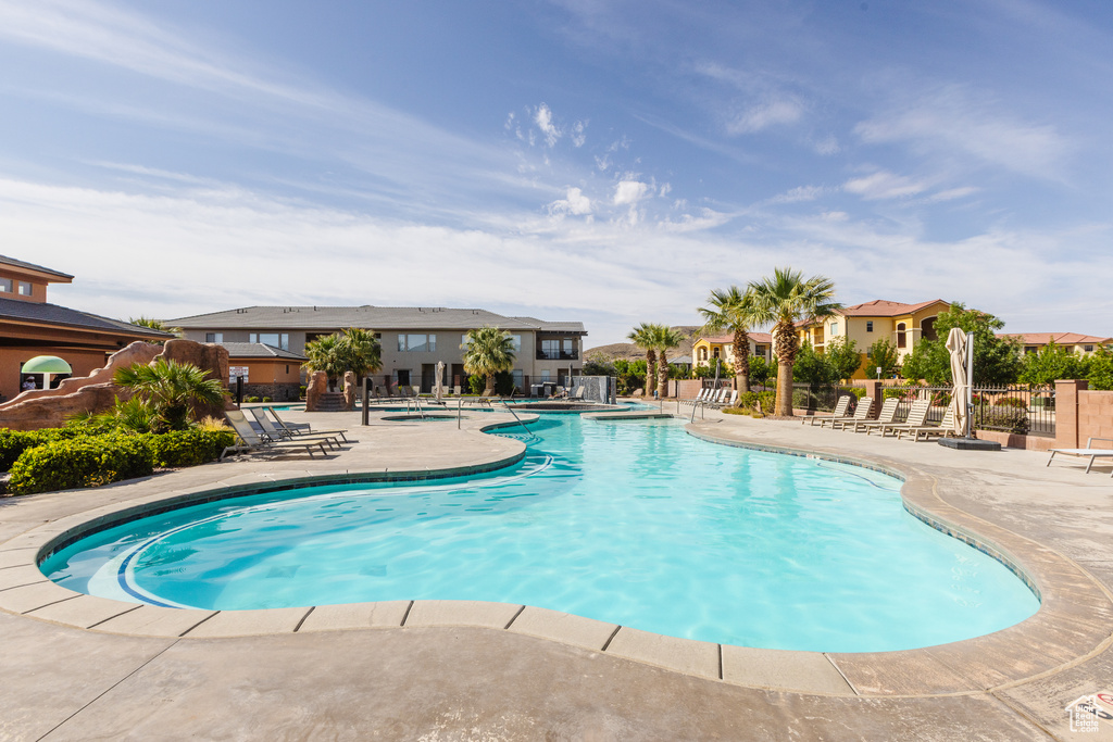 Community pool featuring a patio area and a residential view