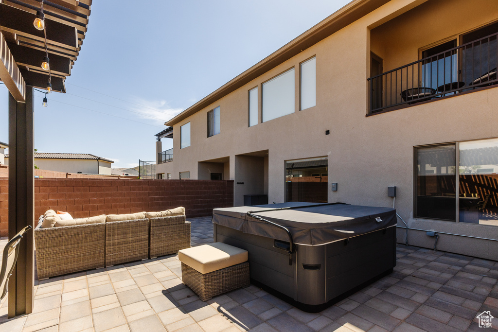 View of patio / terrace with a hot tub and an outdoor hangout area