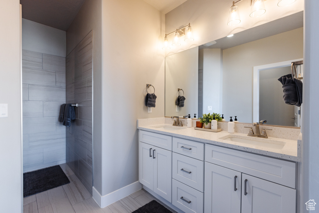 Bathroom with double vanity and baseboards