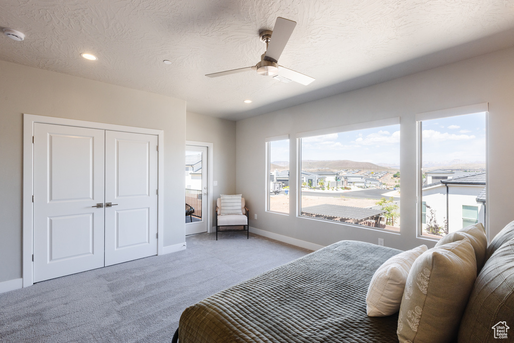 Bedroom with light colored carpet, baseboards, a closet, recessed lighting, and ceiling fan