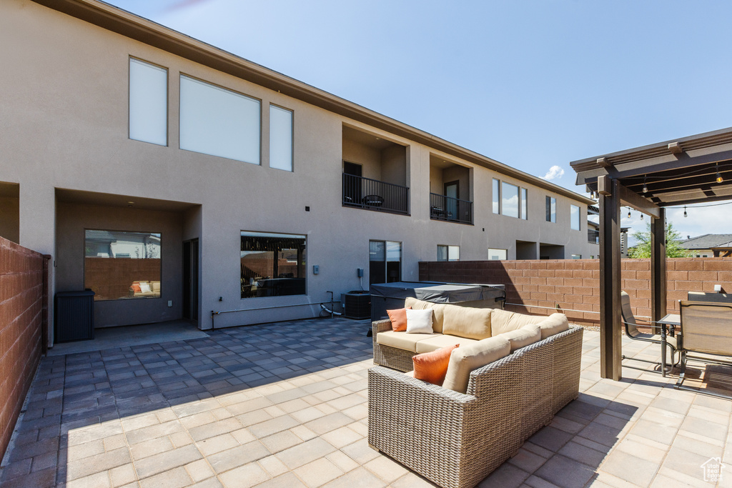 View of patio with cooling unit and an outdoor hangout area