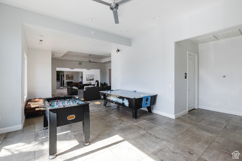 Recreation room featuring baseboards, ceiling fan, recessed lighting, and a tray ceiling