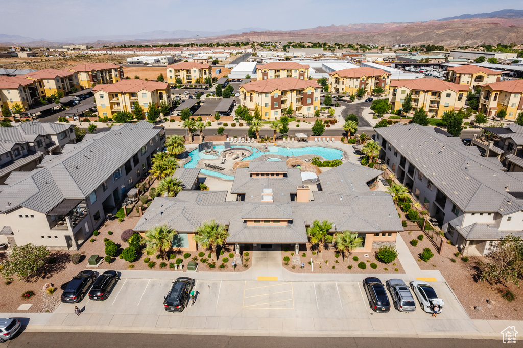 Aerial view of residential area featuring a pool area and mountains
