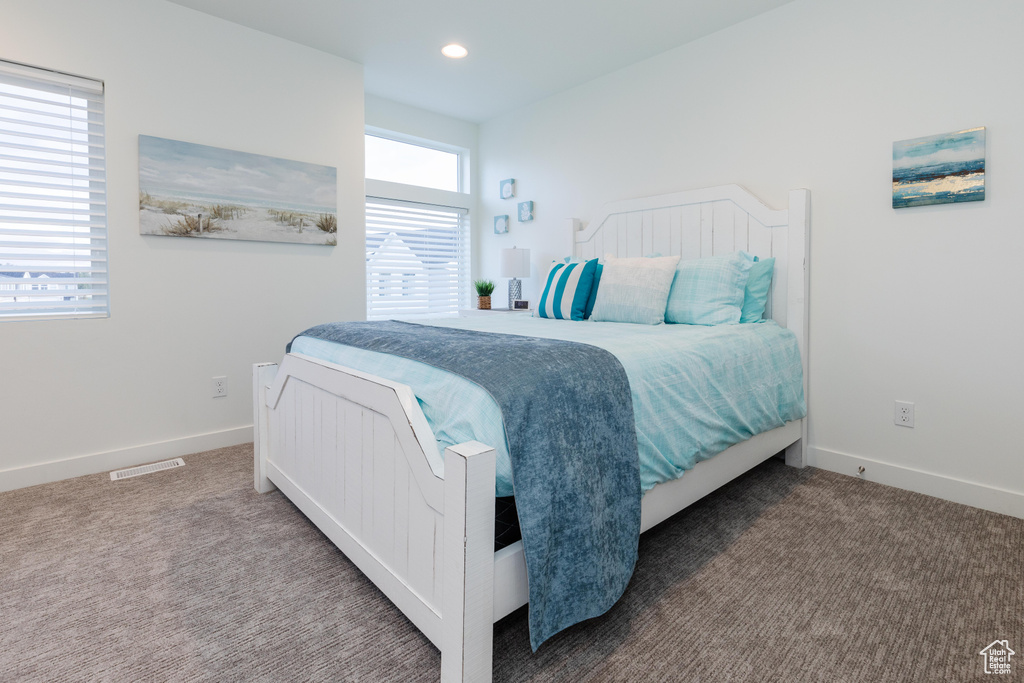 Carpeted bedroom with baseboards and recessed lighting