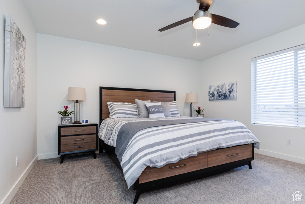 Bedroom featuring carpet floors, multiple windows, baseboards, and recessed lighting