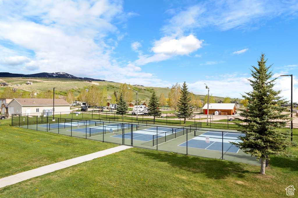 View of tennis court featuring a mountain view