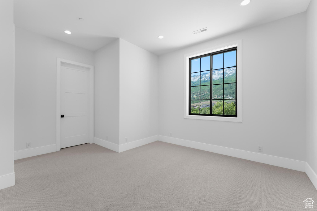 Unfurnished room featuring light carpet, recessed lighting, and baseboards