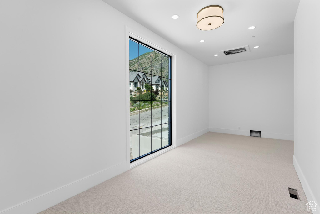 Unfurnished room featuring carpet flooring, recessed lighting, and baseboards