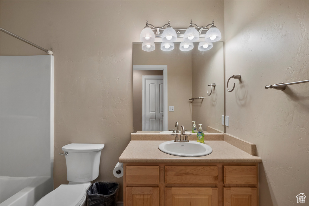 Full bathroom featuring vanity, toilet, and shower / washtub combination