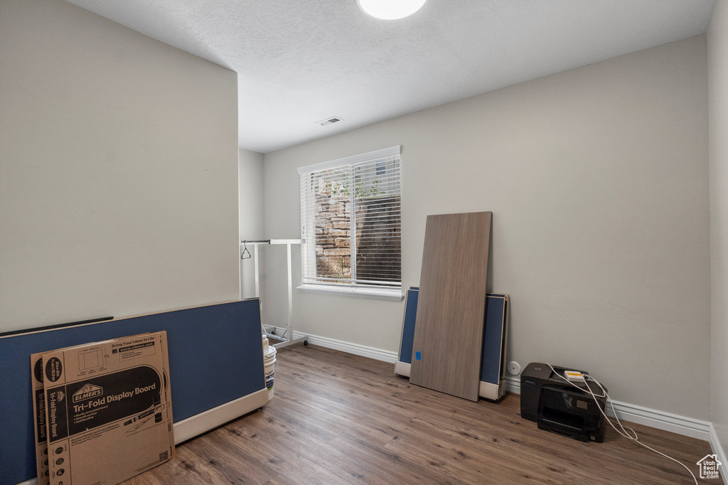 Misc room with wood finished floors and baseboards