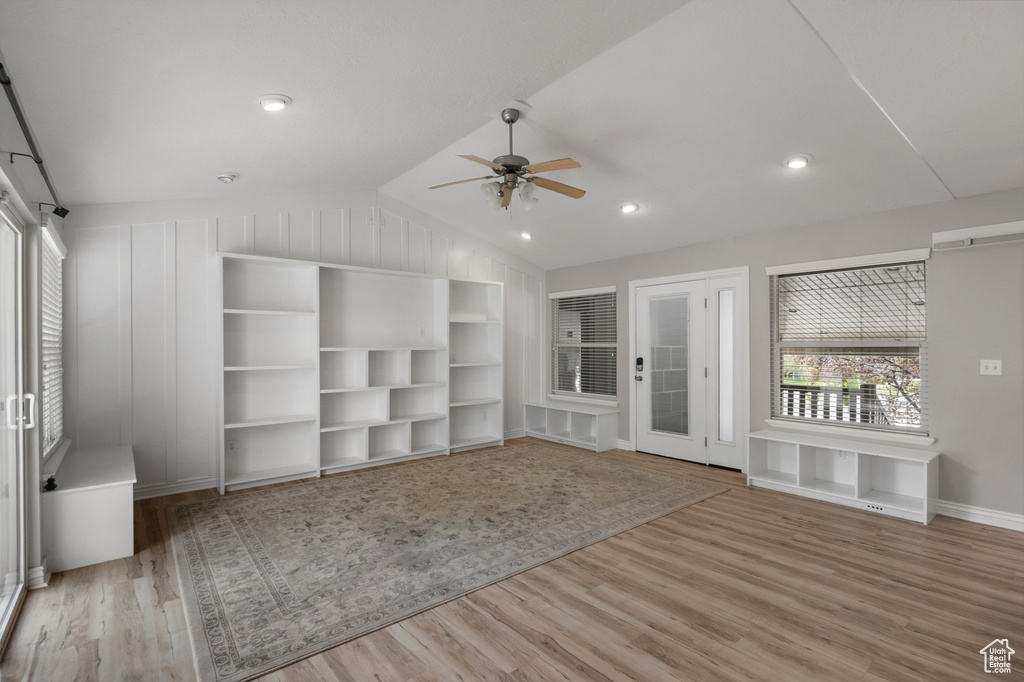 Unfurnished room with a ceiling fan, wood finished floors, vaulted ceiling, baseboards, and recessed lighting