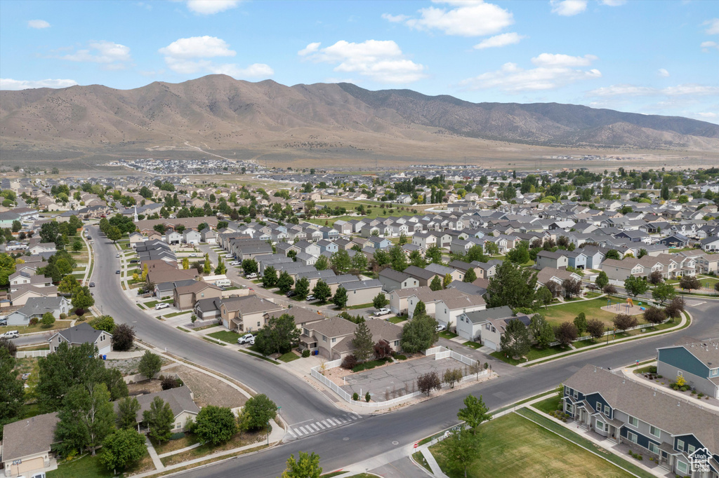 Aerial view of property's location with mountains and nearby suburban area