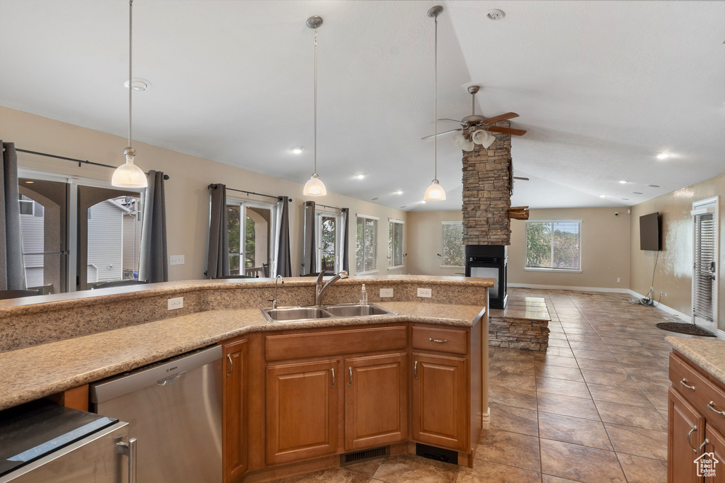 Kitchen with a sink, dishwasher, a ceiling fan, vaulted ceiling, and open floor plan