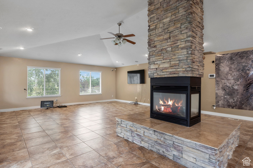 Unfurnished living room featuring a ceiling fan, a fireplace, lofted ceiling, tile patterned flooring, and recessed lighting