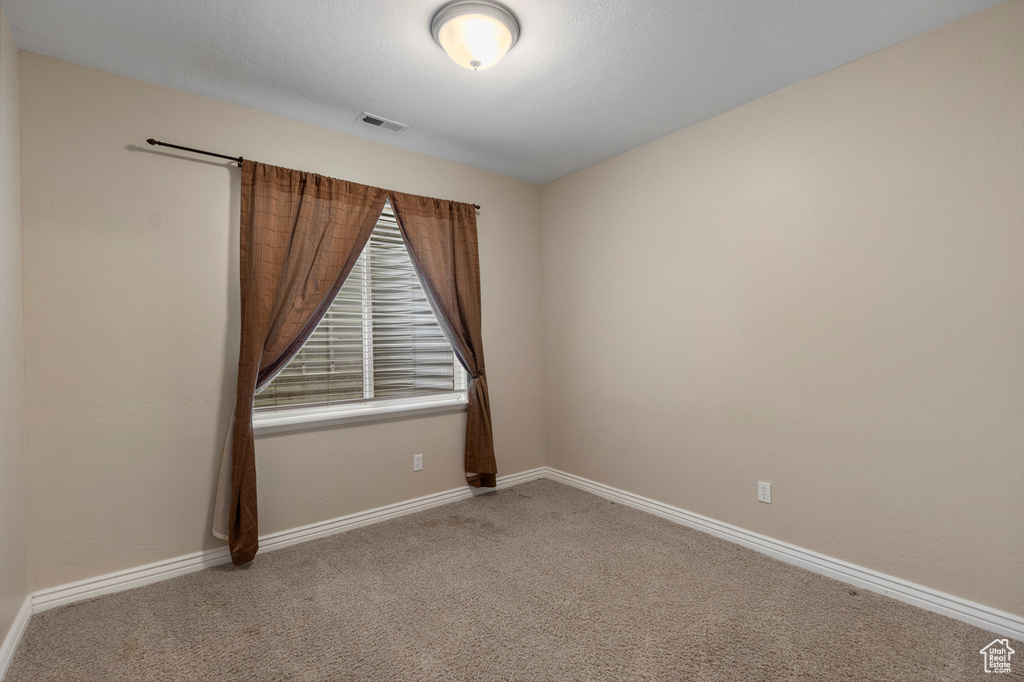 Unfurnished room with carpet and baseboards