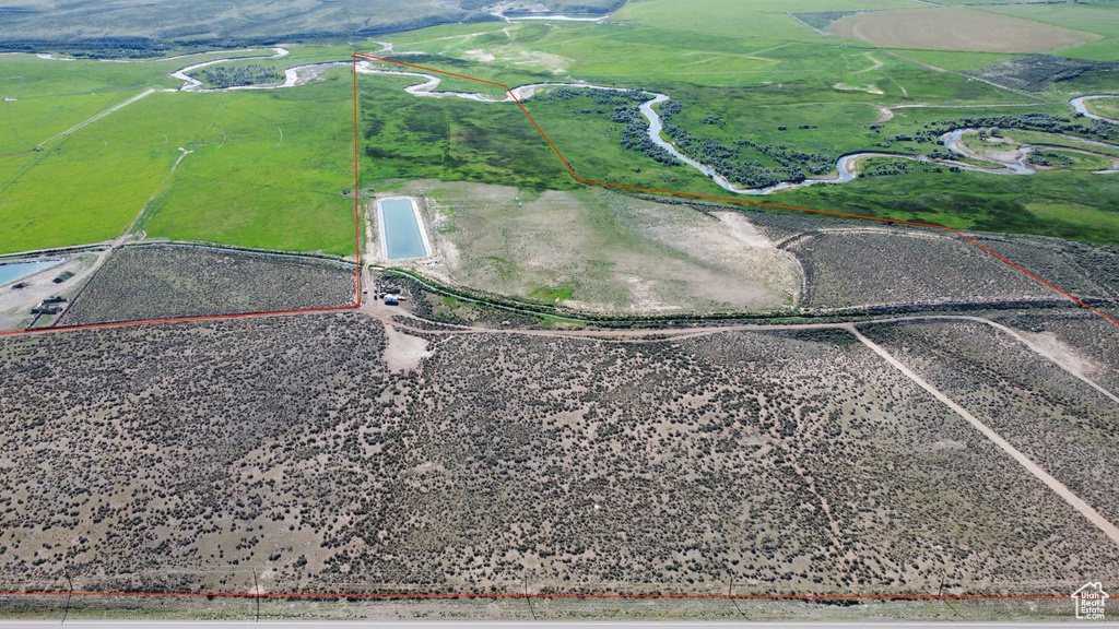 Aerial view of sparsely populated area with property parcel outlined