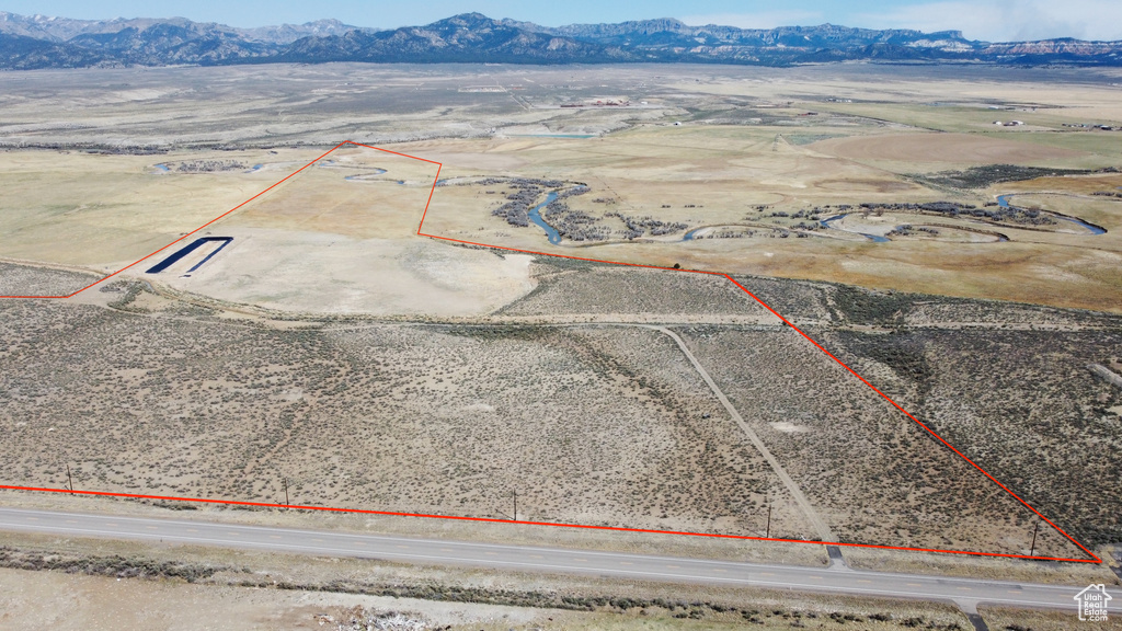 View of rural area with property parcel outlined, mountains, and a desert landscape