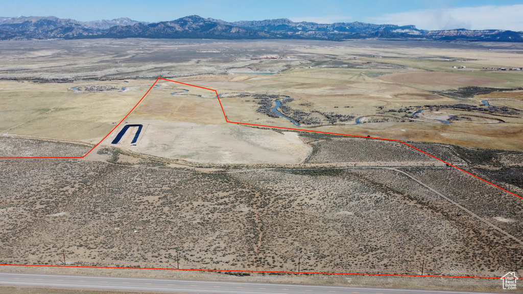 Overview of rural landscape featuring property parcel outlined, a mountain backdrop, and a desert landscape