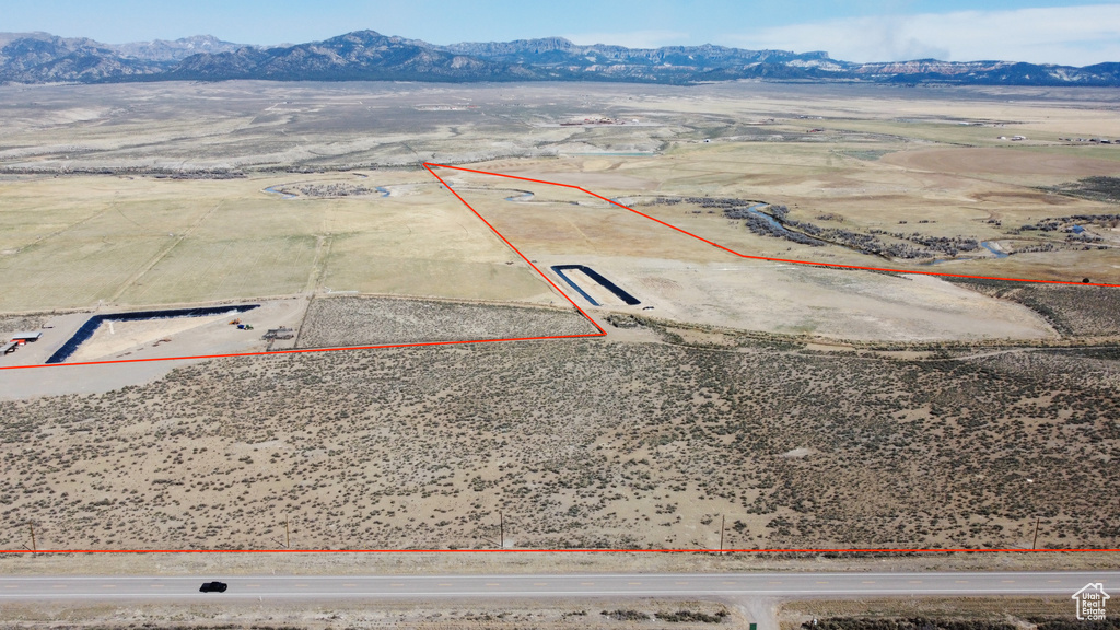 View of rural area featuring property boundaries highlighted, mountains, and a desert landscape