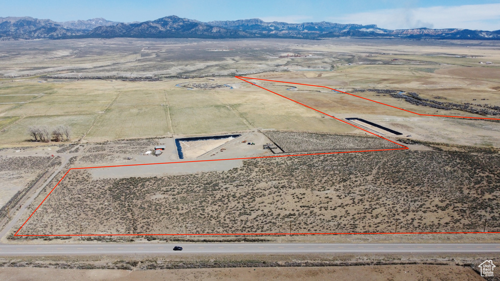 Overview of rural landscape with a mountain backdrop, property boundaries highlighted, and a desert landscape