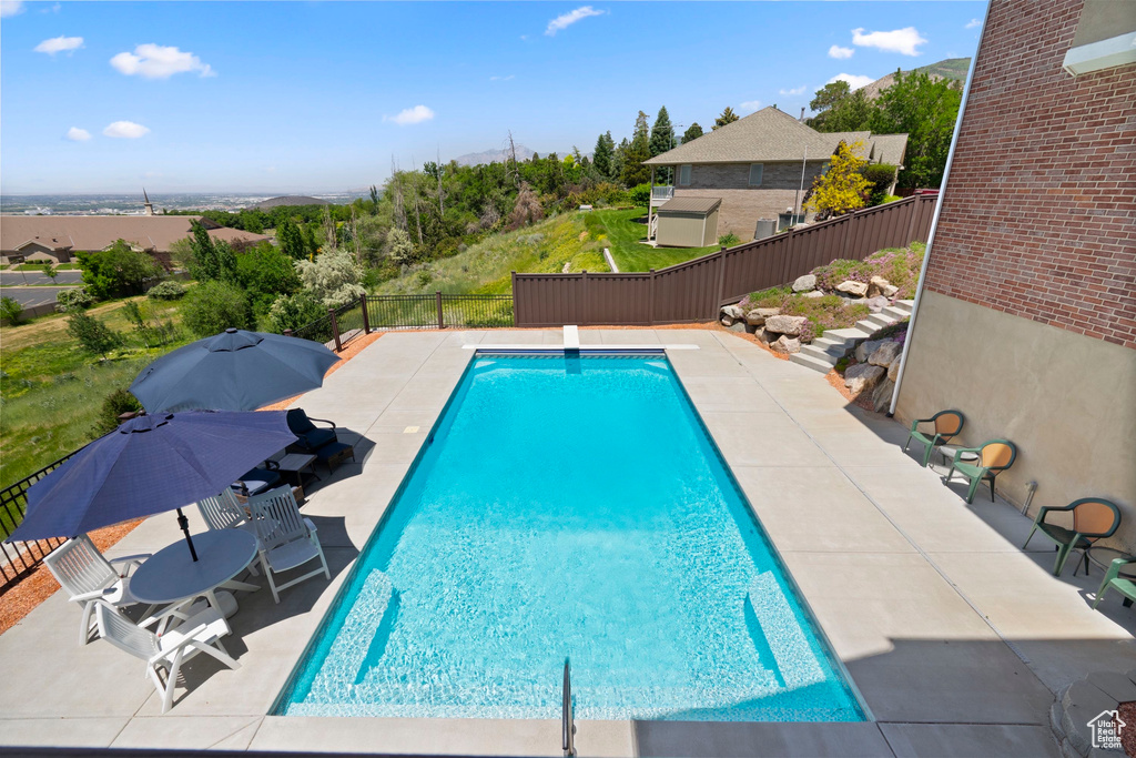 View of swimming pool with a patio area