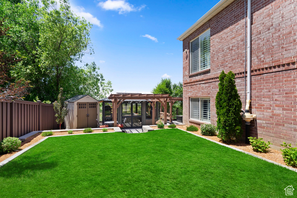 View of yard with a pergola and a patio