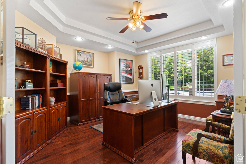 Office featuring a raised ceiling, a ceiling fan, and dark wood-type flooring
